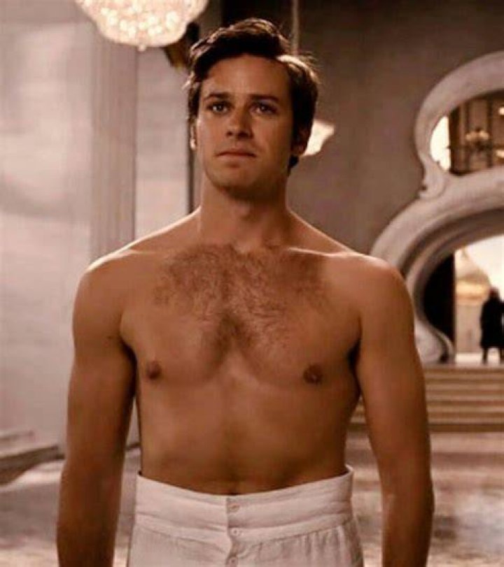 Armie Hammer goes shirtless & reveals new tattoo on rare outing before